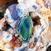 Handmade Gary Green Jasper pendant wrapped in sterling silver wire, featuring deep green, blue-green, and tan hues in an elegant design.